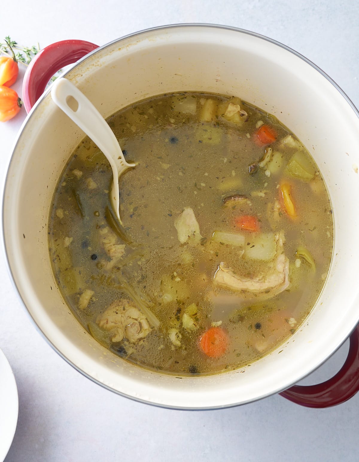 Stock pot filled with mannish water, a goat, tripe and vegetable soup.