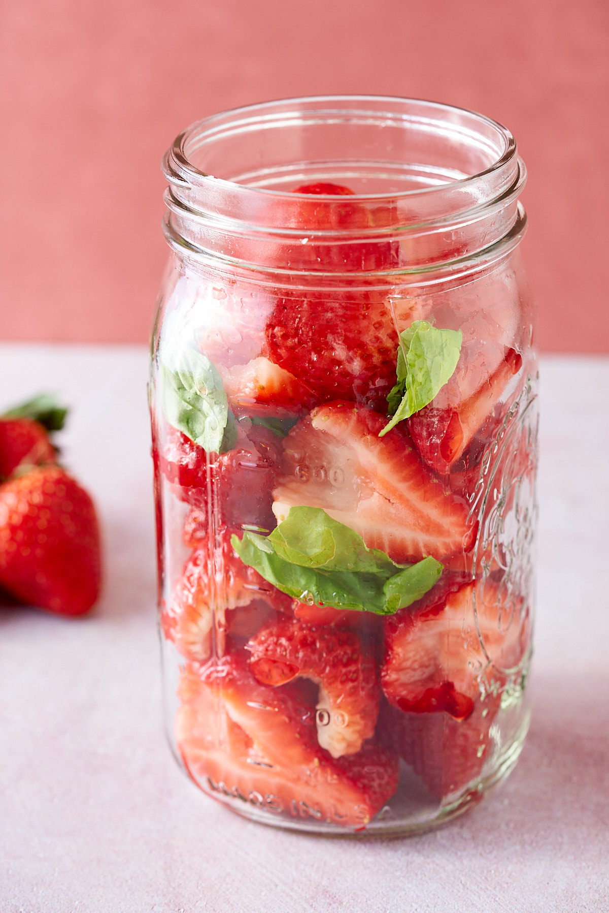 Strawberries added to the mason jar.