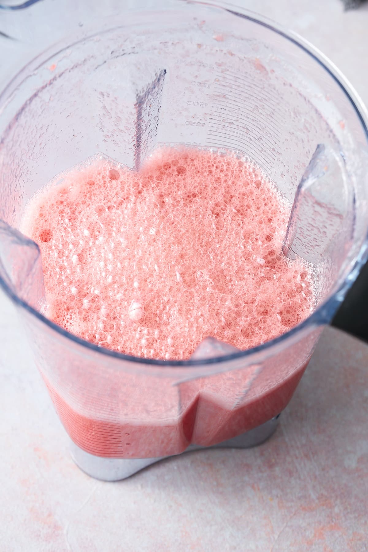 A blender jug filled with blended watermelon.