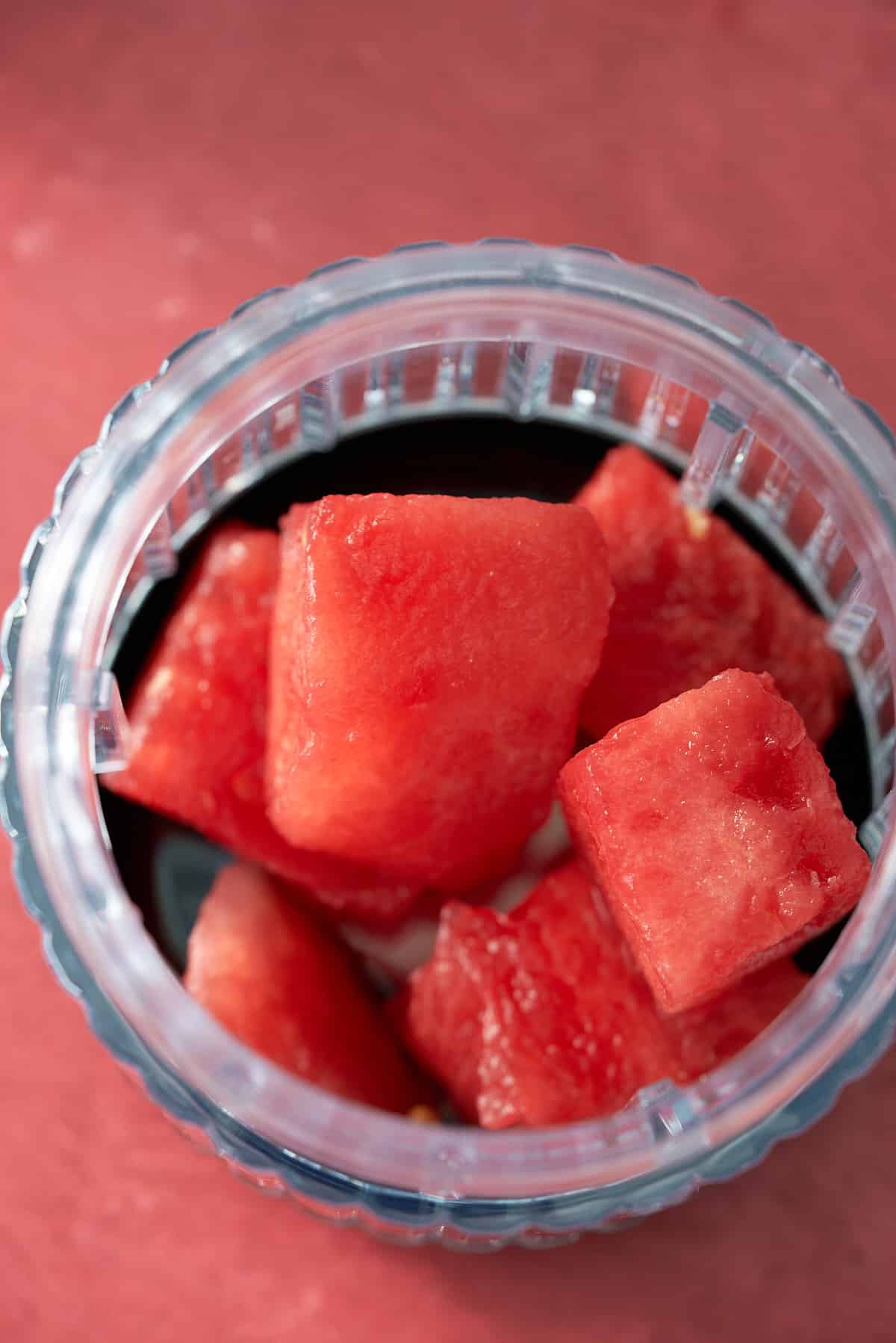 chunks of watermelon in a blender cup.