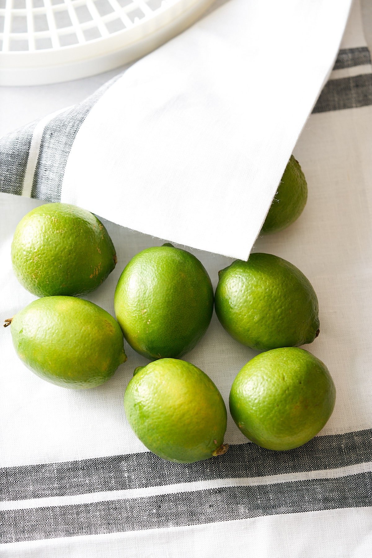 fresh limes on white kitchen towel