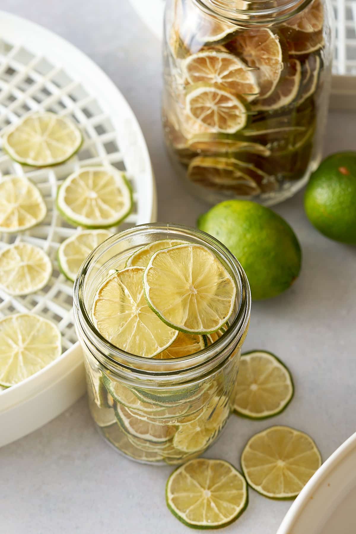 dehydrated limes in glass container with other limes around