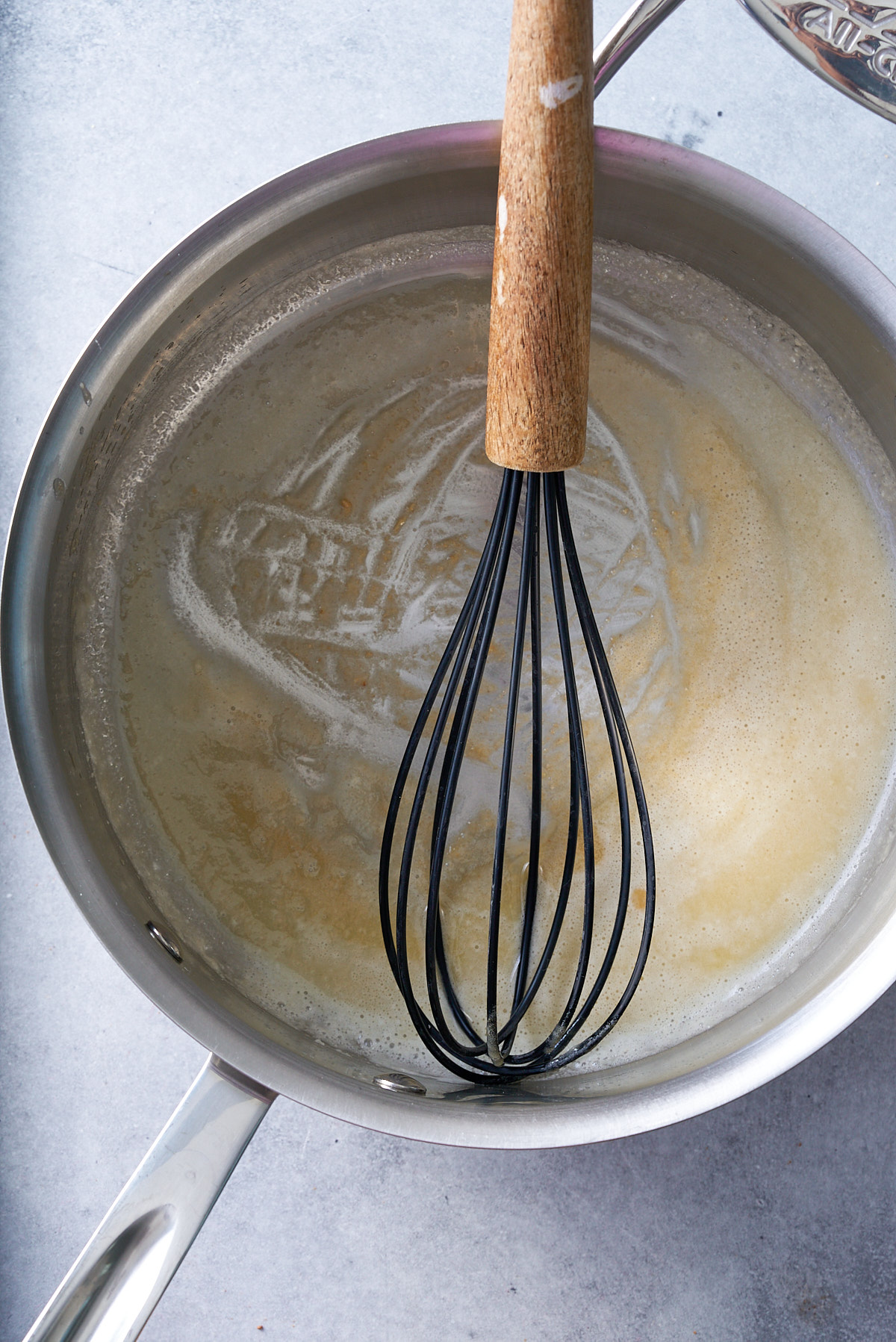 flour and butter being whisked in pan