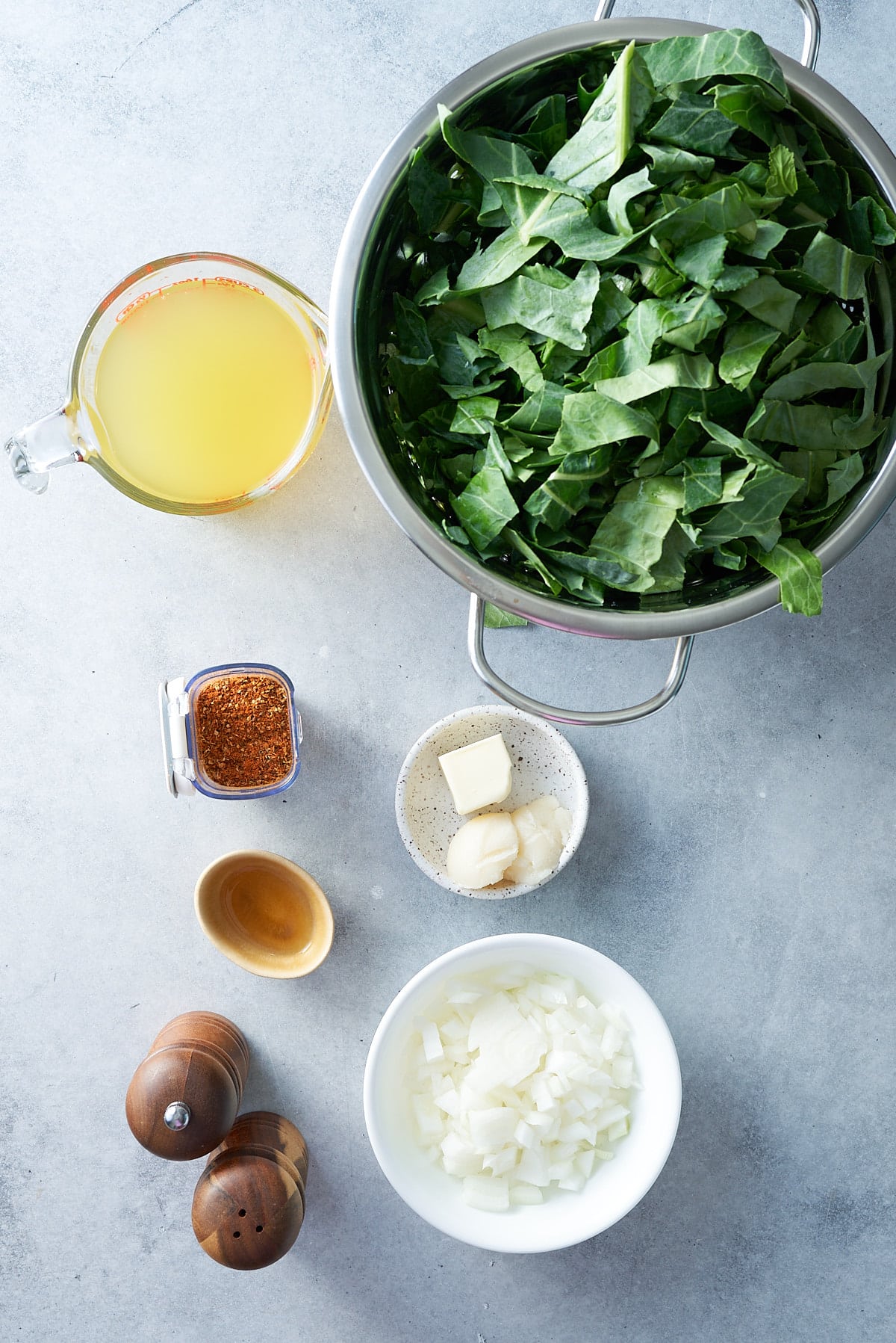 ingredients for slow cooker collard greens on blue background