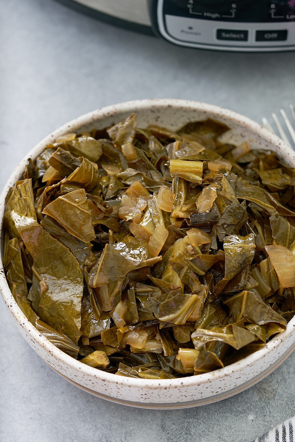 cooked collards greens in a white dish