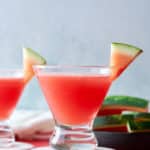 watermelon martini, in glass, in front of sliced watermelon