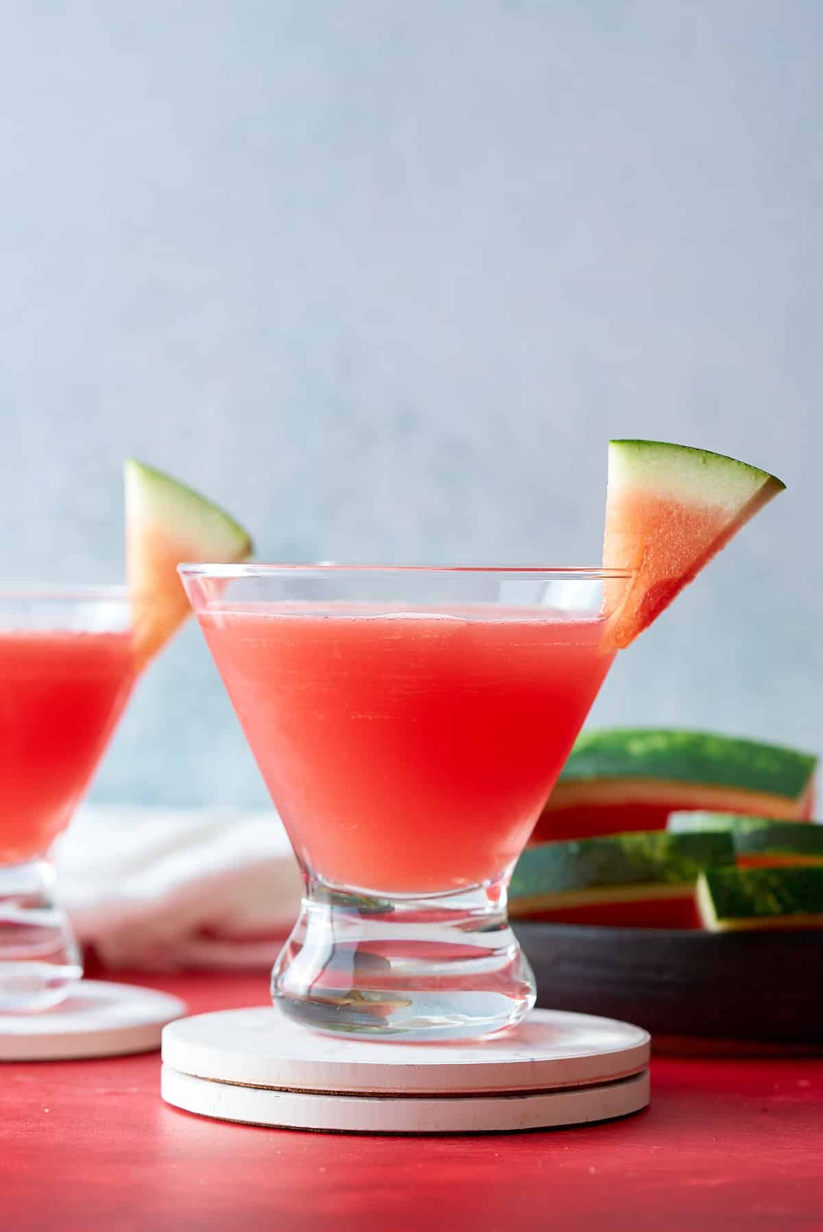 watermelon martini, in glass, in front of sliced watermelon
