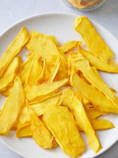 dehydrated mango slices on a white plate