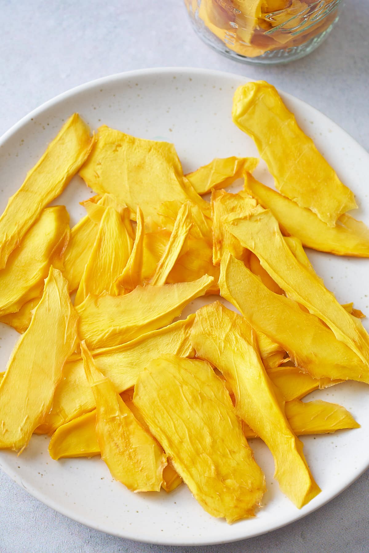 dehydrated mango slices on a white plate