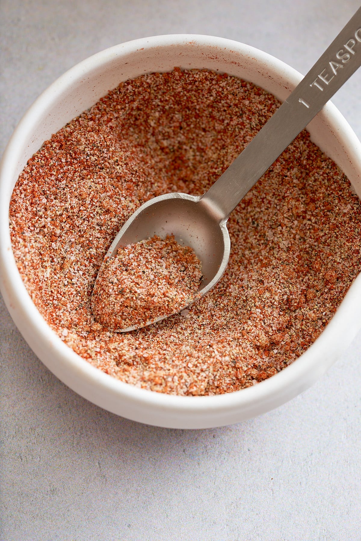 Hamburger seasoning in a small white dish.