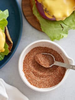 Hamburger seasoning in a small white dish.