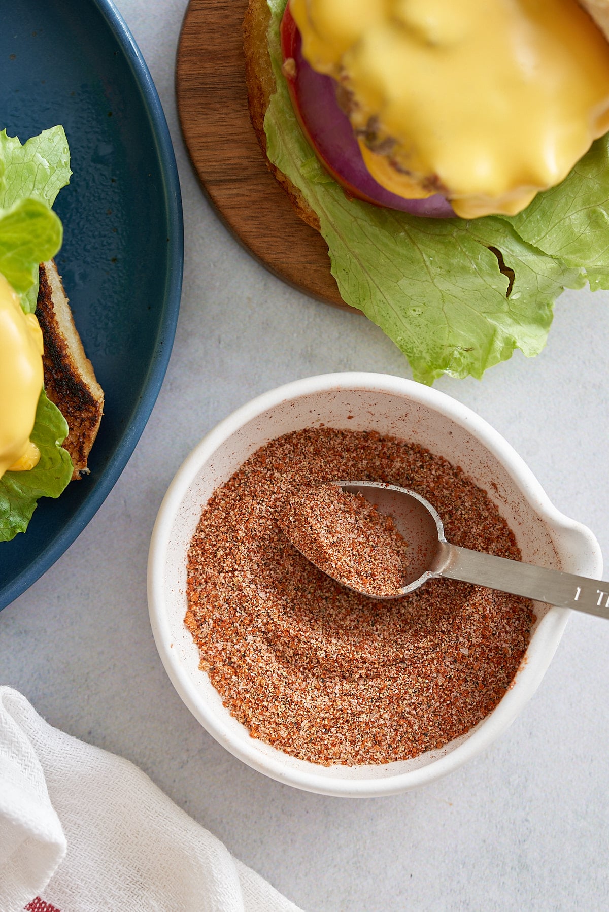 Hamburger seasoning in a small white dish.