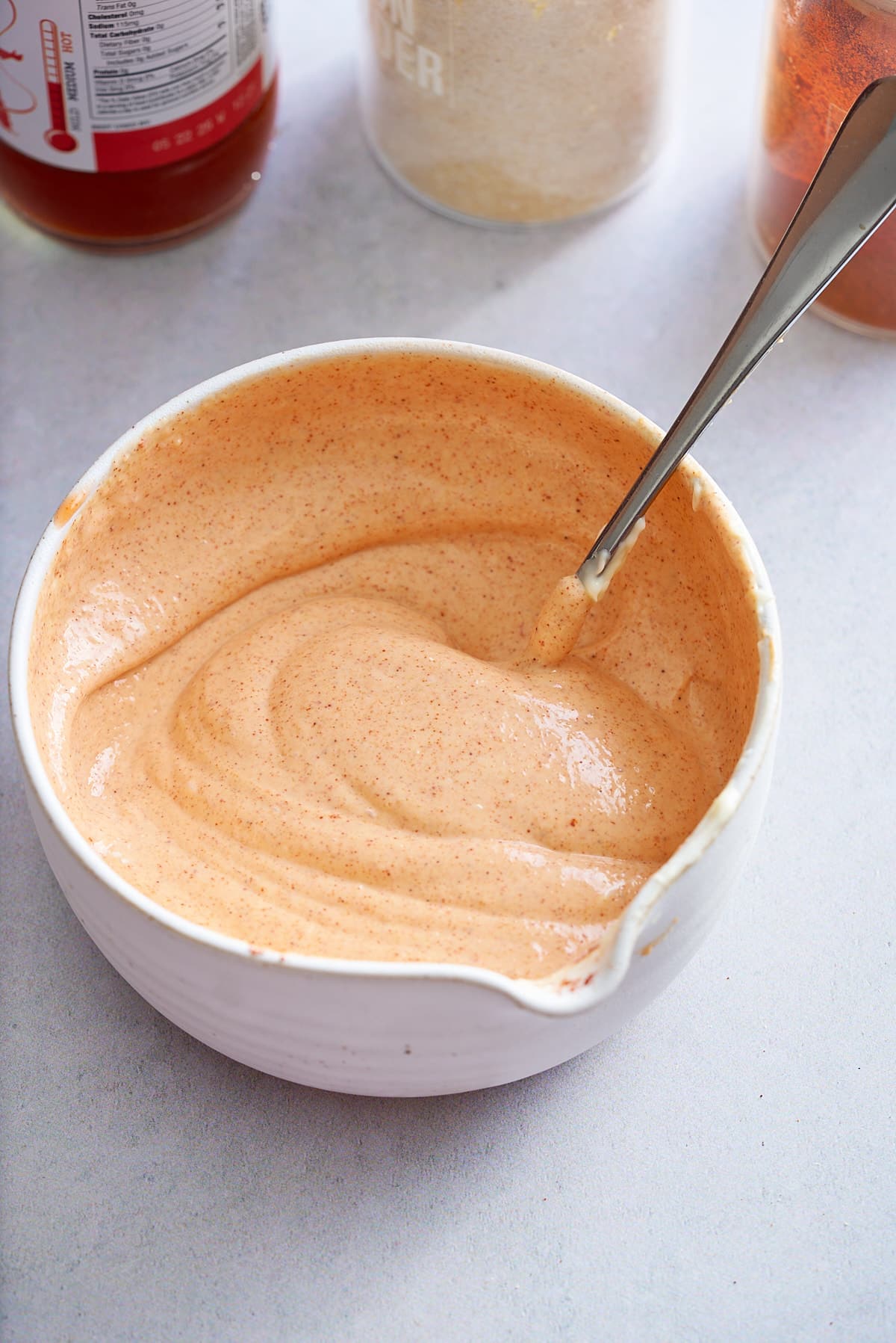 spicy mayonnaise mixed together and ready to serve in a white bowl.