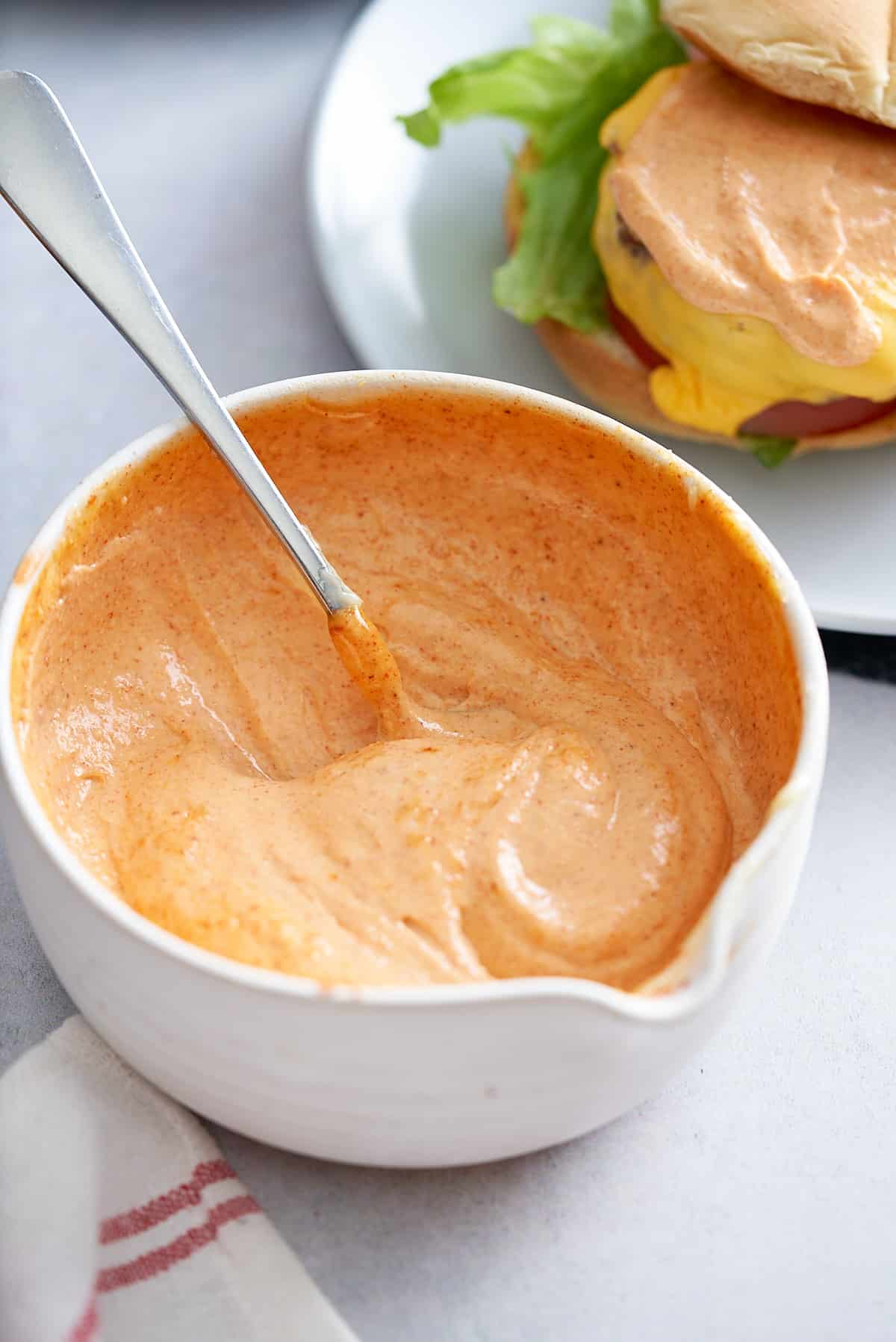 spicy mayonnaise mixed together and ready to serve in a white bowl.