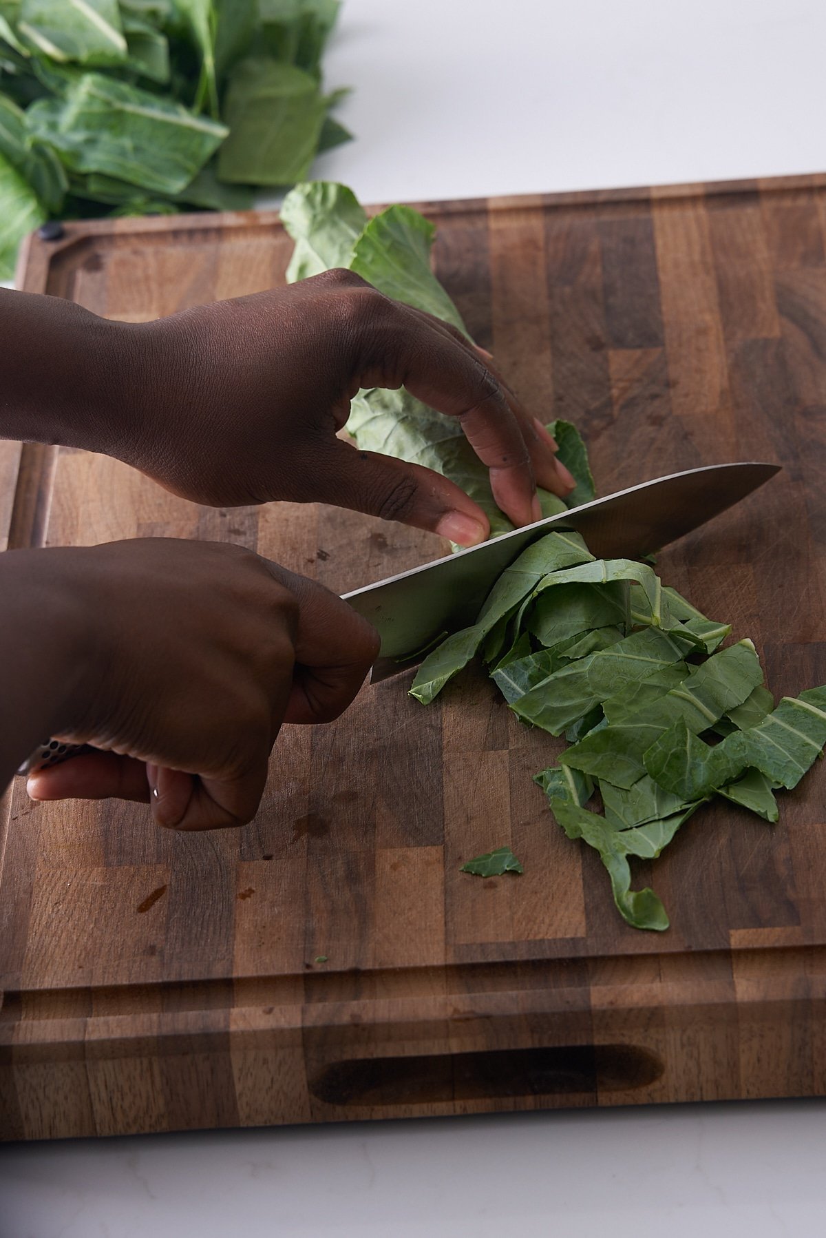 collard greens being sliced