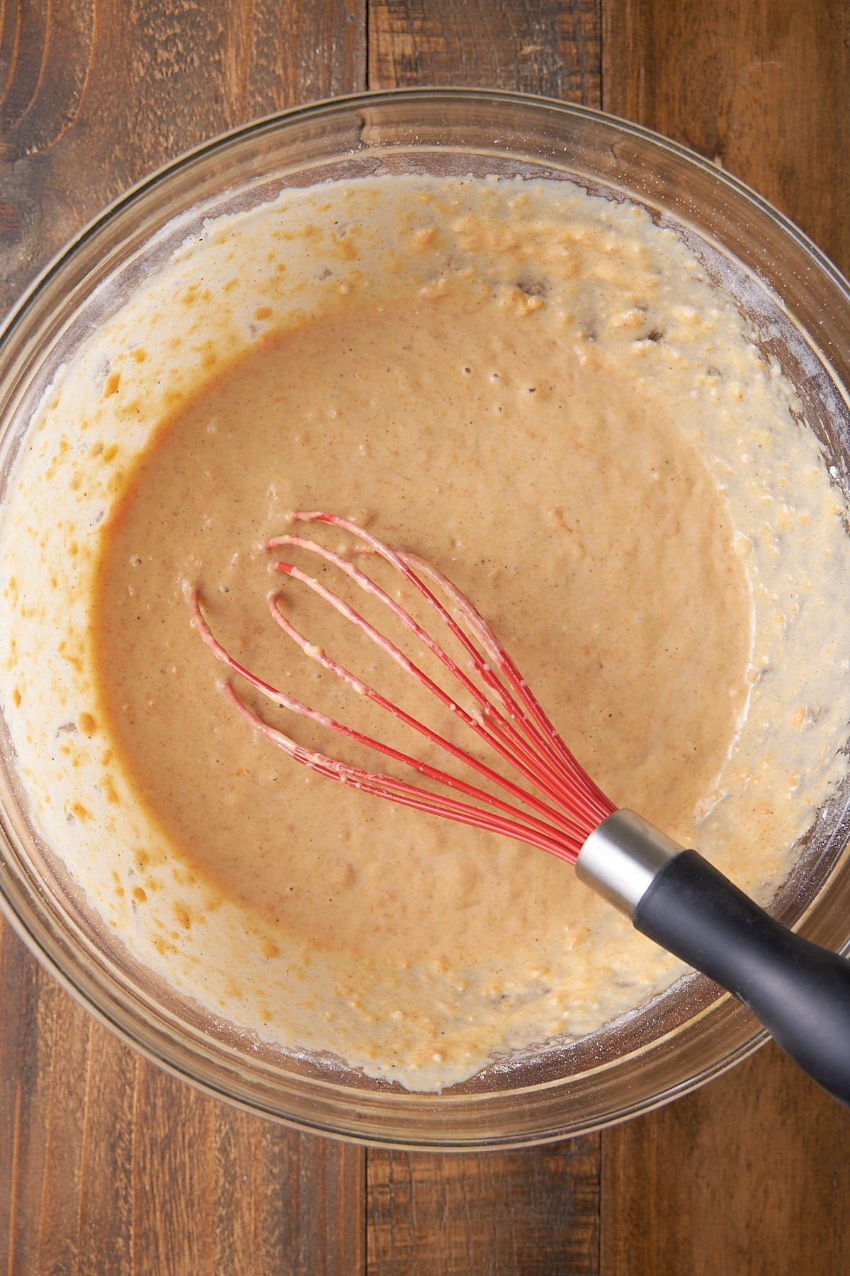 A large mixing bowl filled with sweet potato pancake batter.