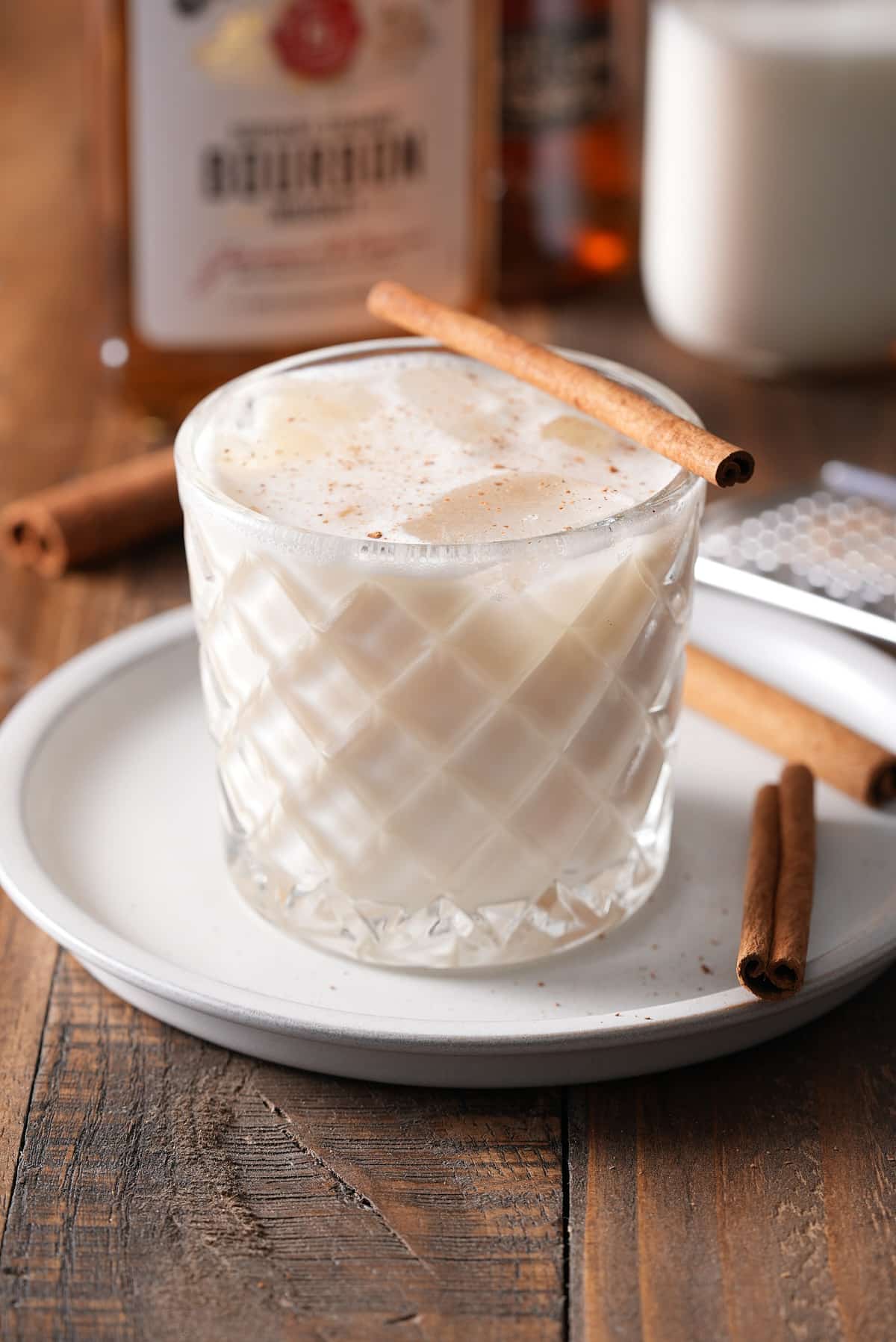 Bourbon milk punch served with a cinnamon stick.