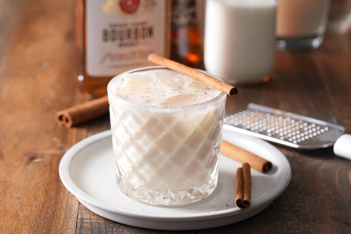 Bourbon milk punch served with a cinnamon stick.