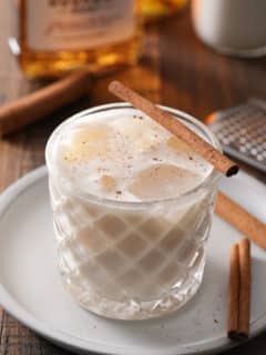 Bourbon milk punch served with a cinnamon stick.