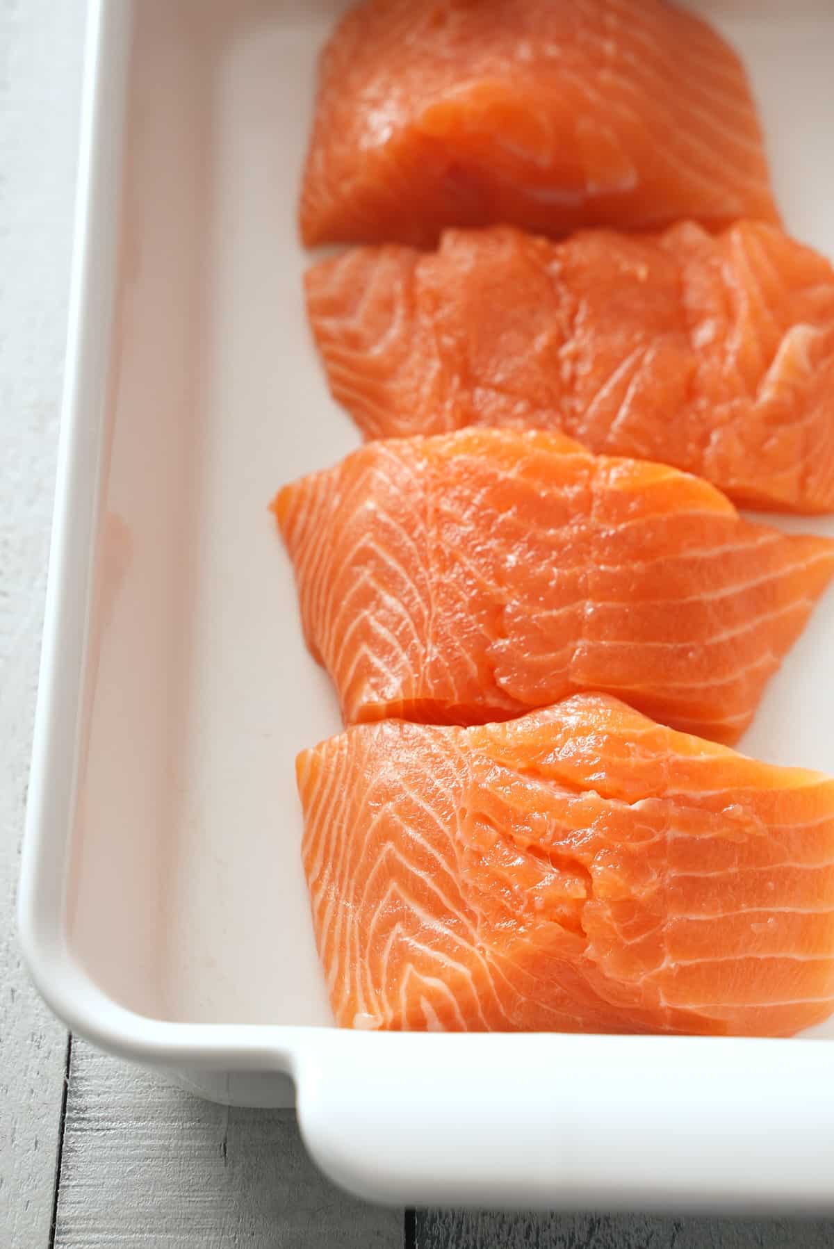 Salmon filets in a shallow baking dish.