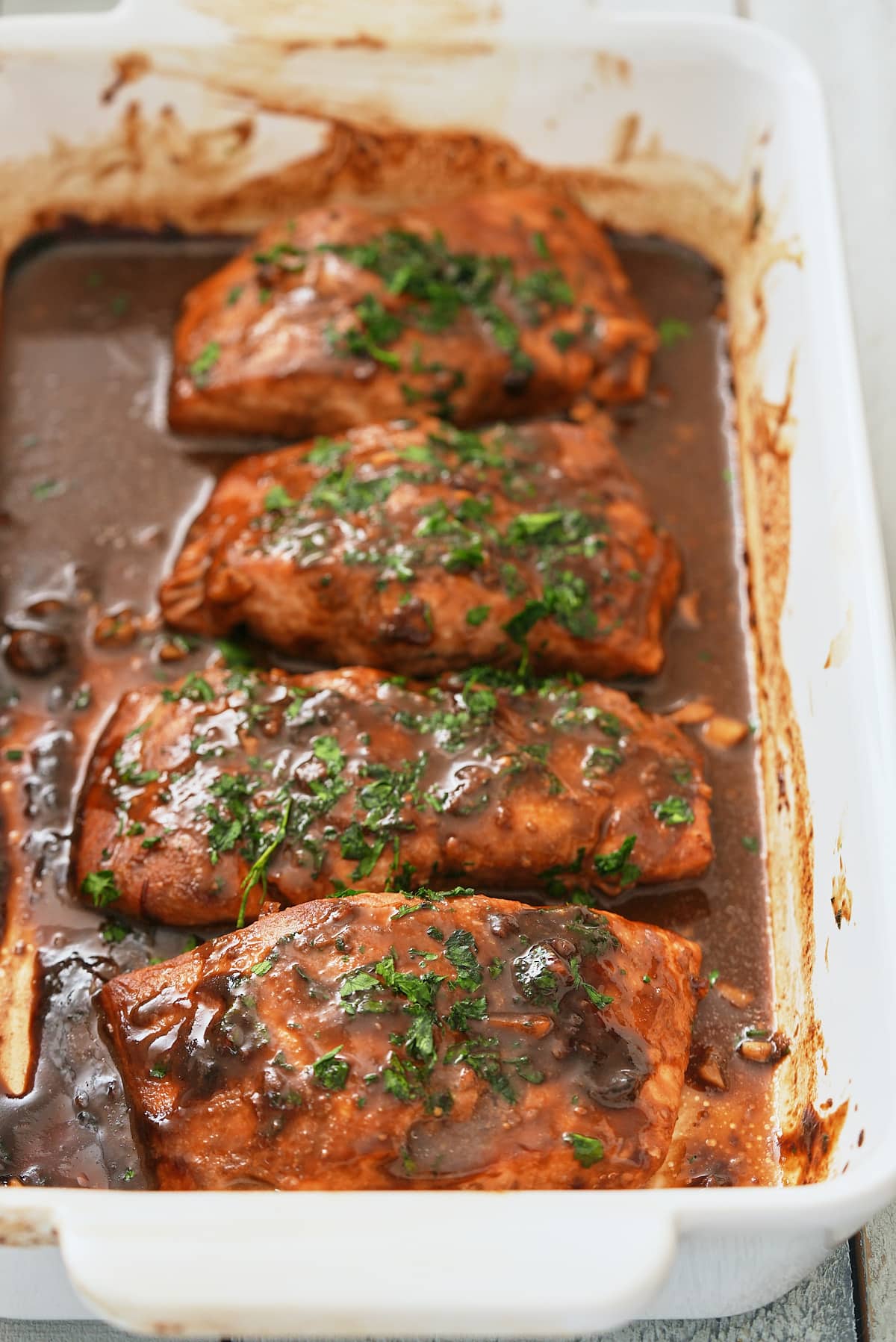 Baked marinated salmon that has been garnished.