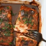 Baked marinated salmon that has been garnished.