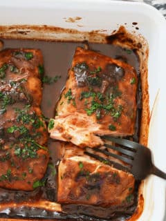 Baked marinated salmon that has been garnished.