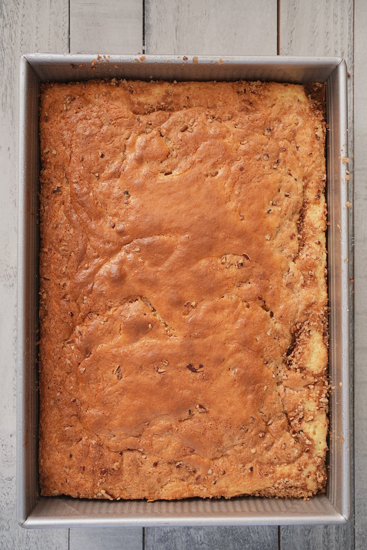 A rectangular cake tin filled with baked honey bun cake.