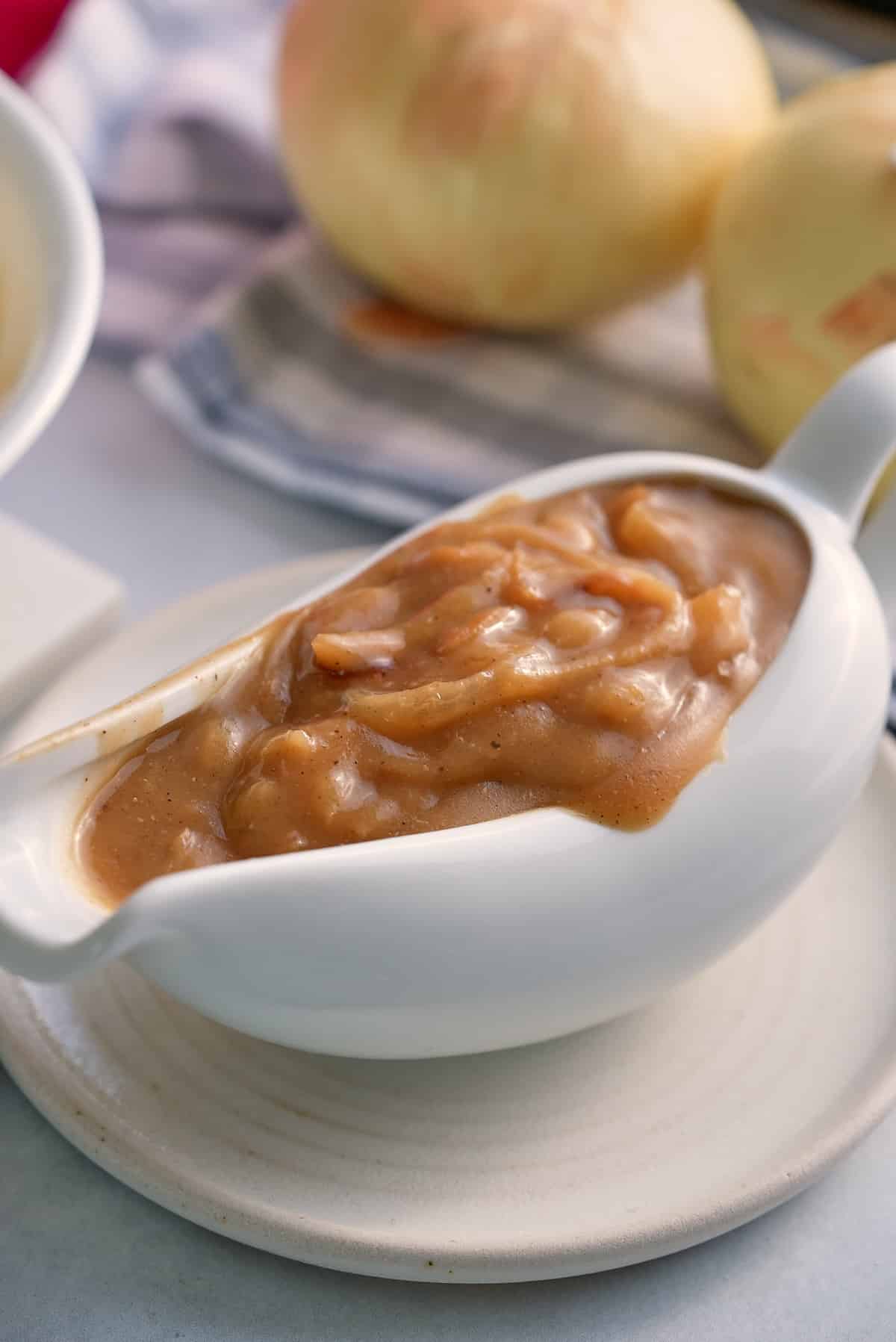 A white gravy jug filled with onion gravy.