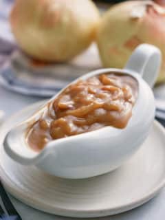 A white gravy jug filled with onion gravy.