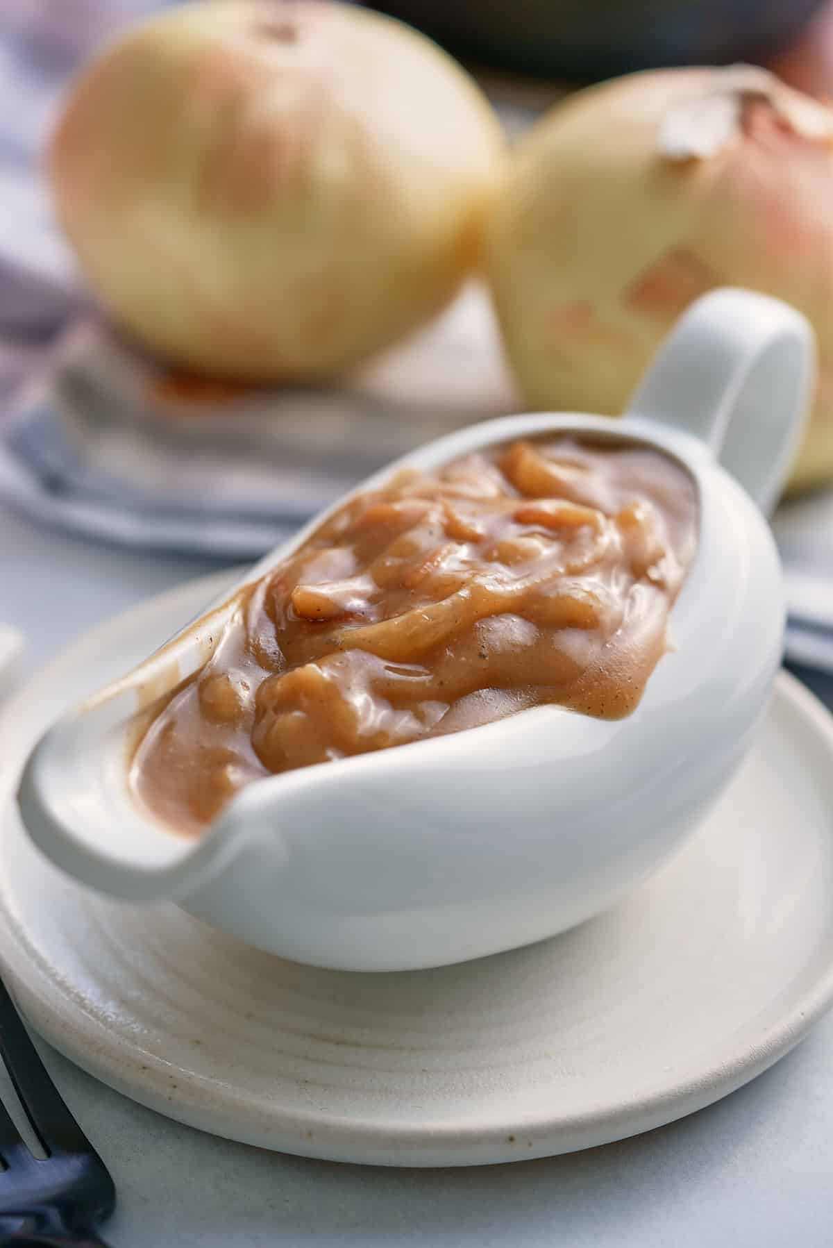 A white gravy jug filled with onion gravy.