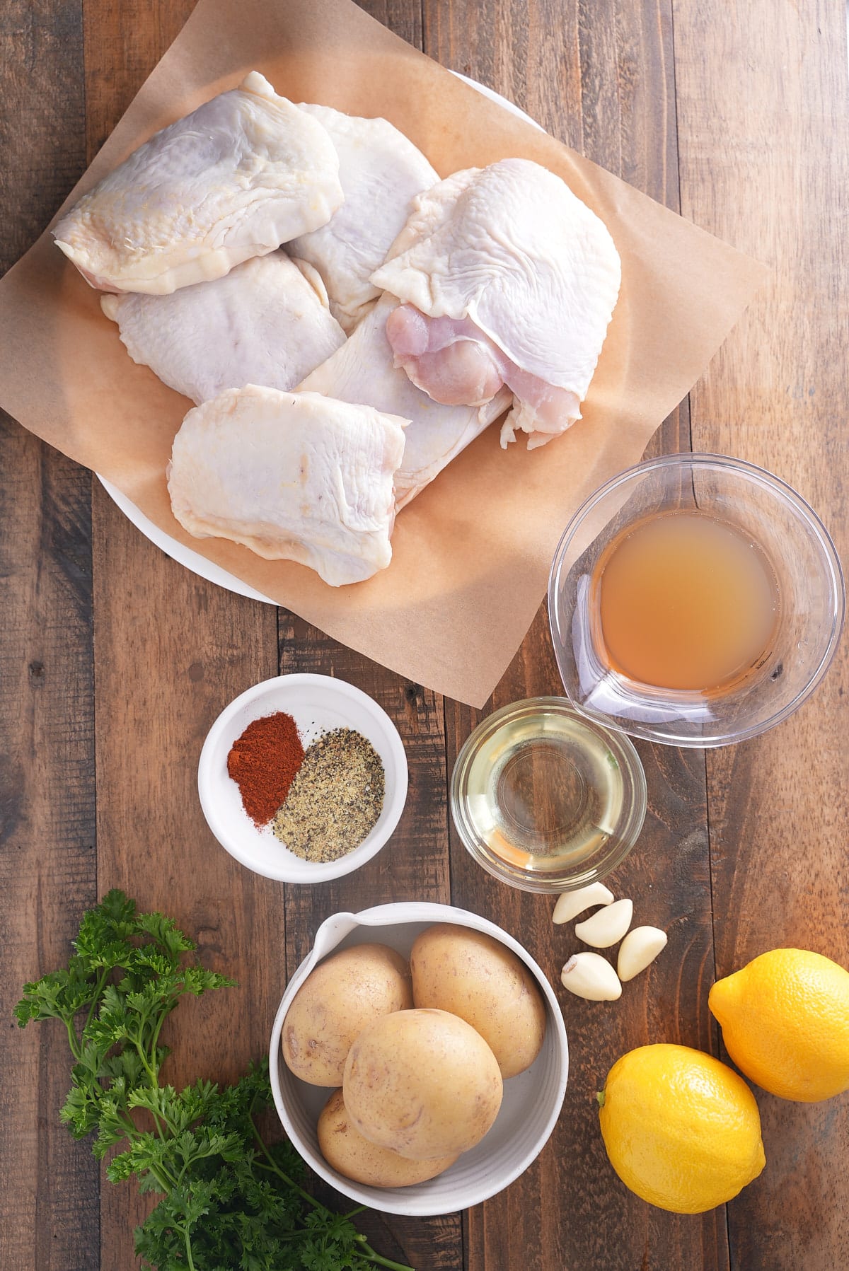 ingredients for braised chicken thighs on wooden table