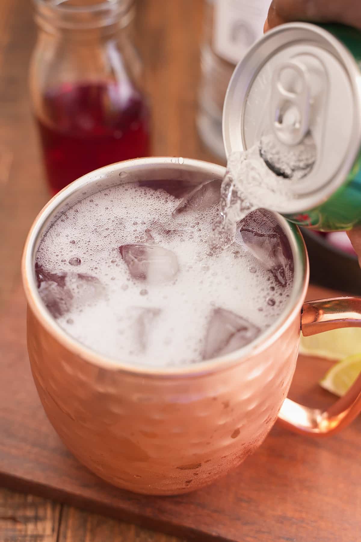 Canned ginger beer being poured in the glass.