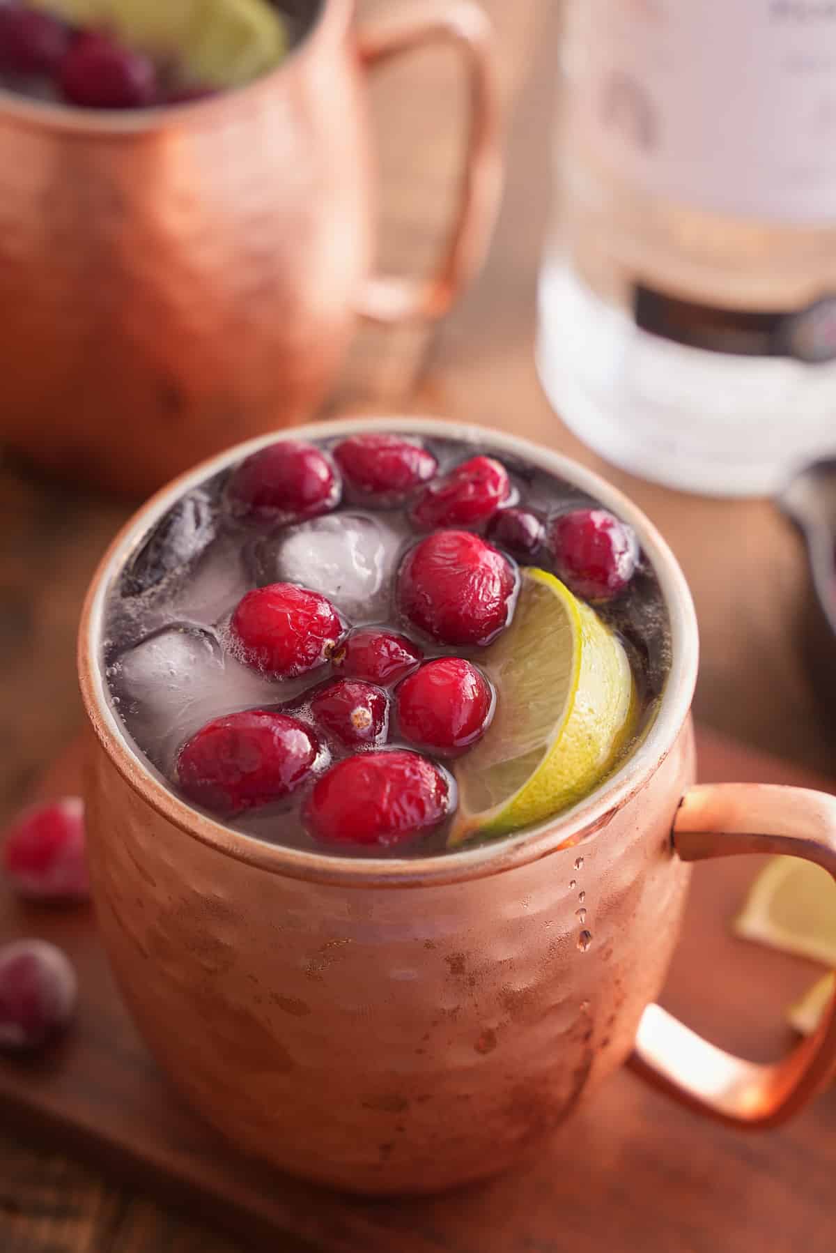 cranberry Moscow mule garnished with cranberries.