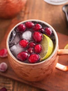 cranberry Moscow mule garnished with cranberries.