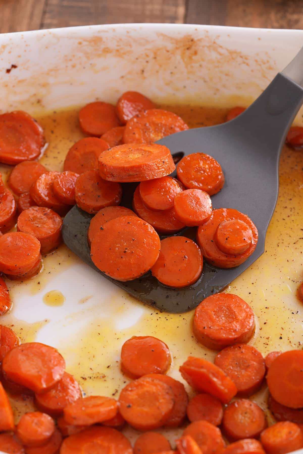 Oven proof dish filled with honey roasted carrots.