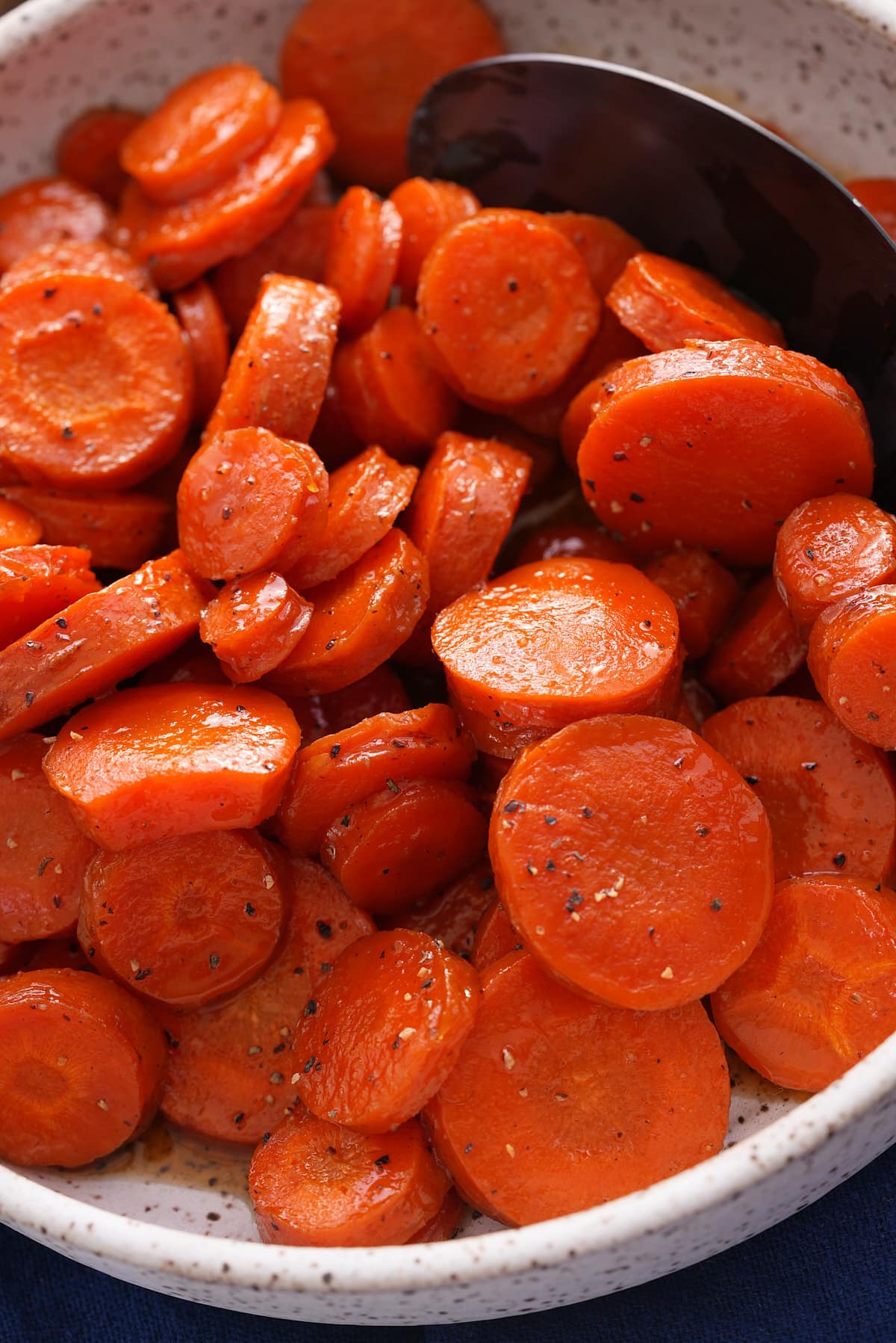 A bowl filled with sliced honey roasted carrots.