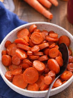 A bowl filled with sliced honey roasted carrots.