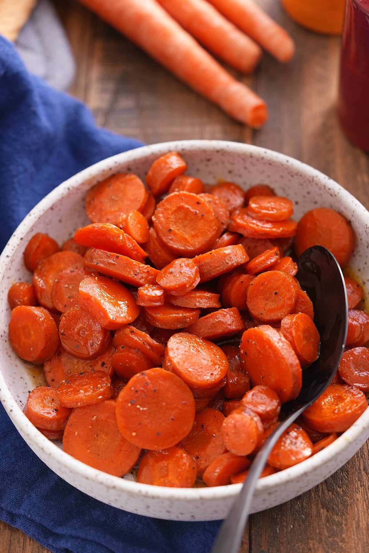 A bowl filled with sliced honey roasted carrots.