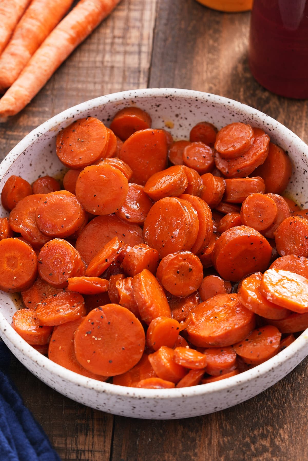 A bowl filled with sliced honey roasted carrots.