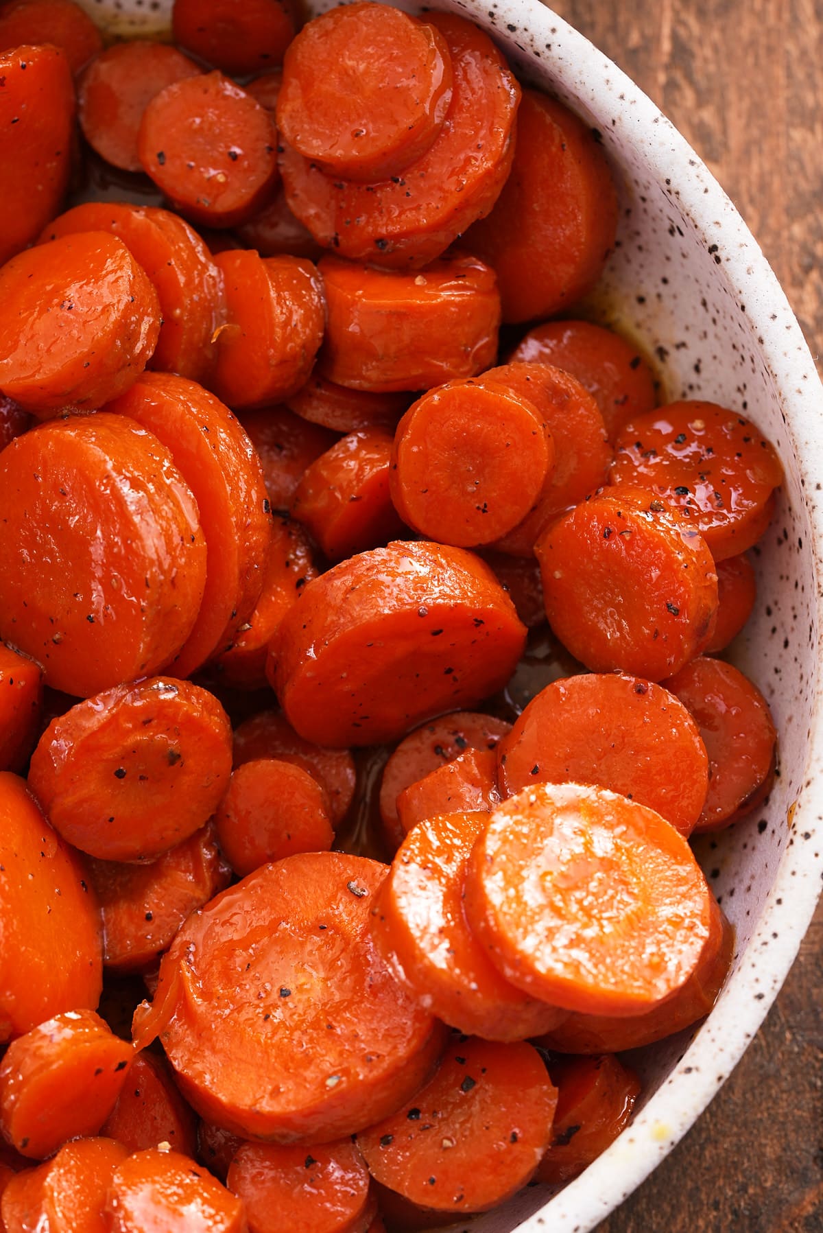 A bowl filled with sliced honey roasted carrots.