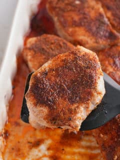 Oven baked pork chop on a spatula.