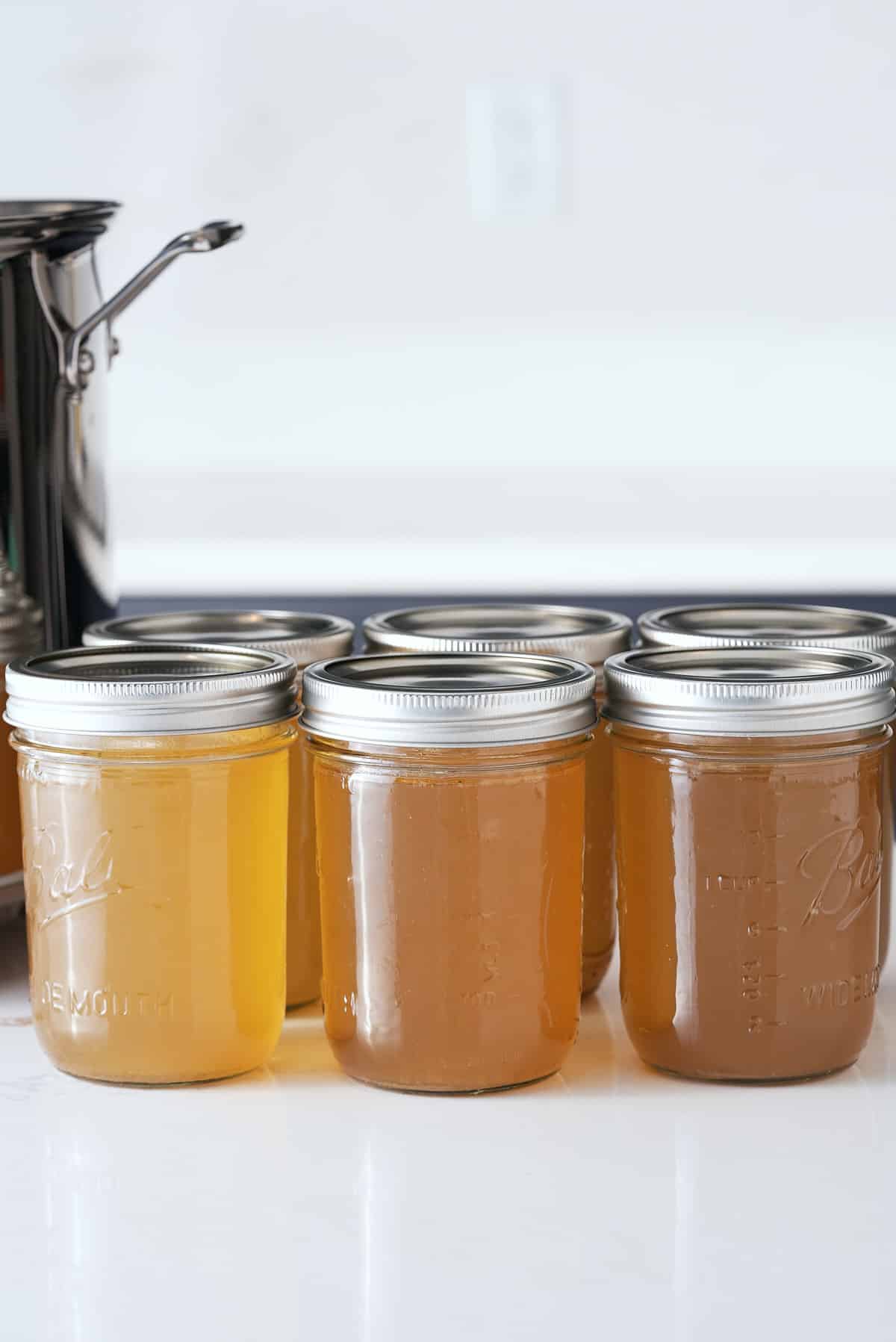 Jars of cooked and cooled turkey stock.