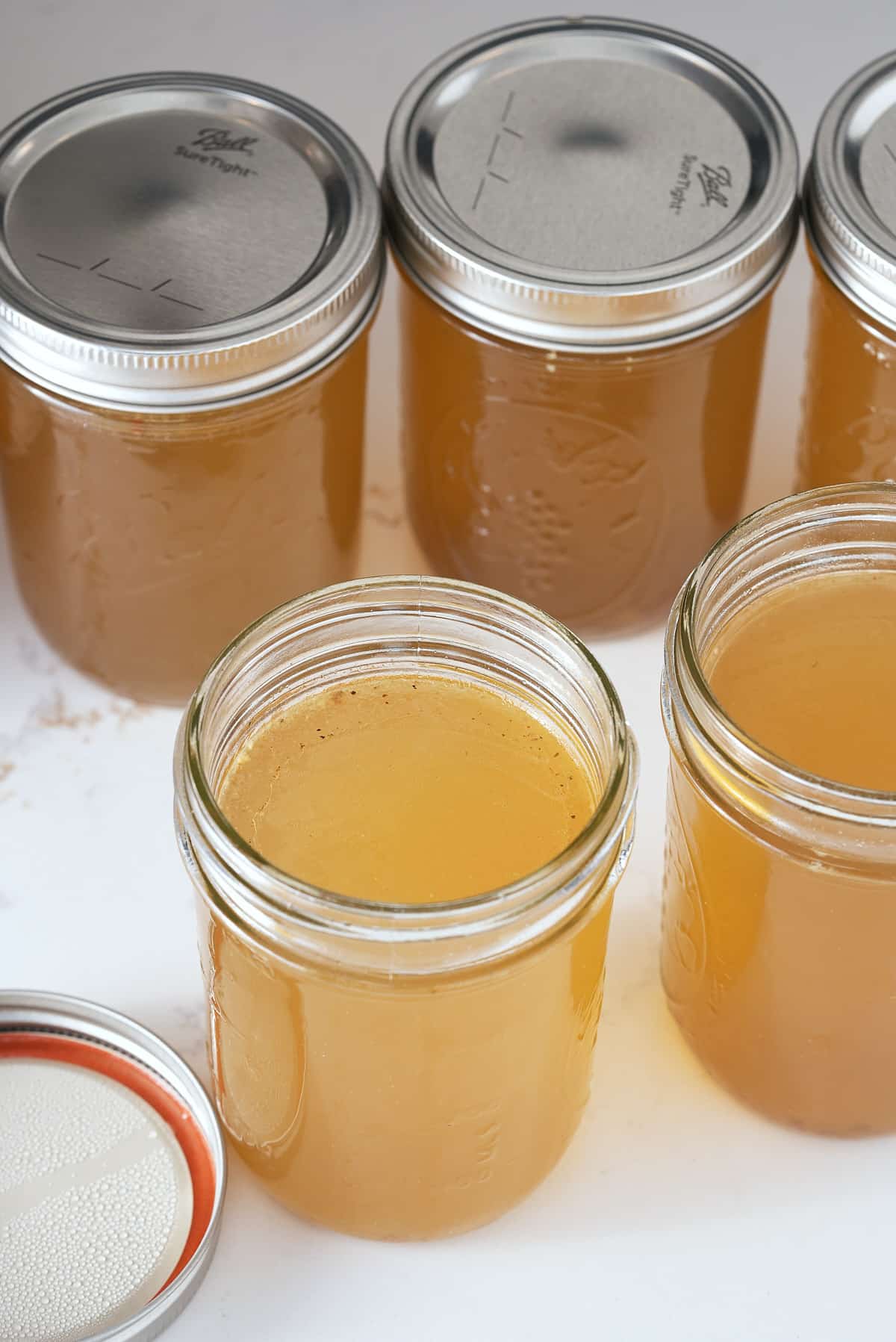 Jars of cooked and cooled turkey stock.