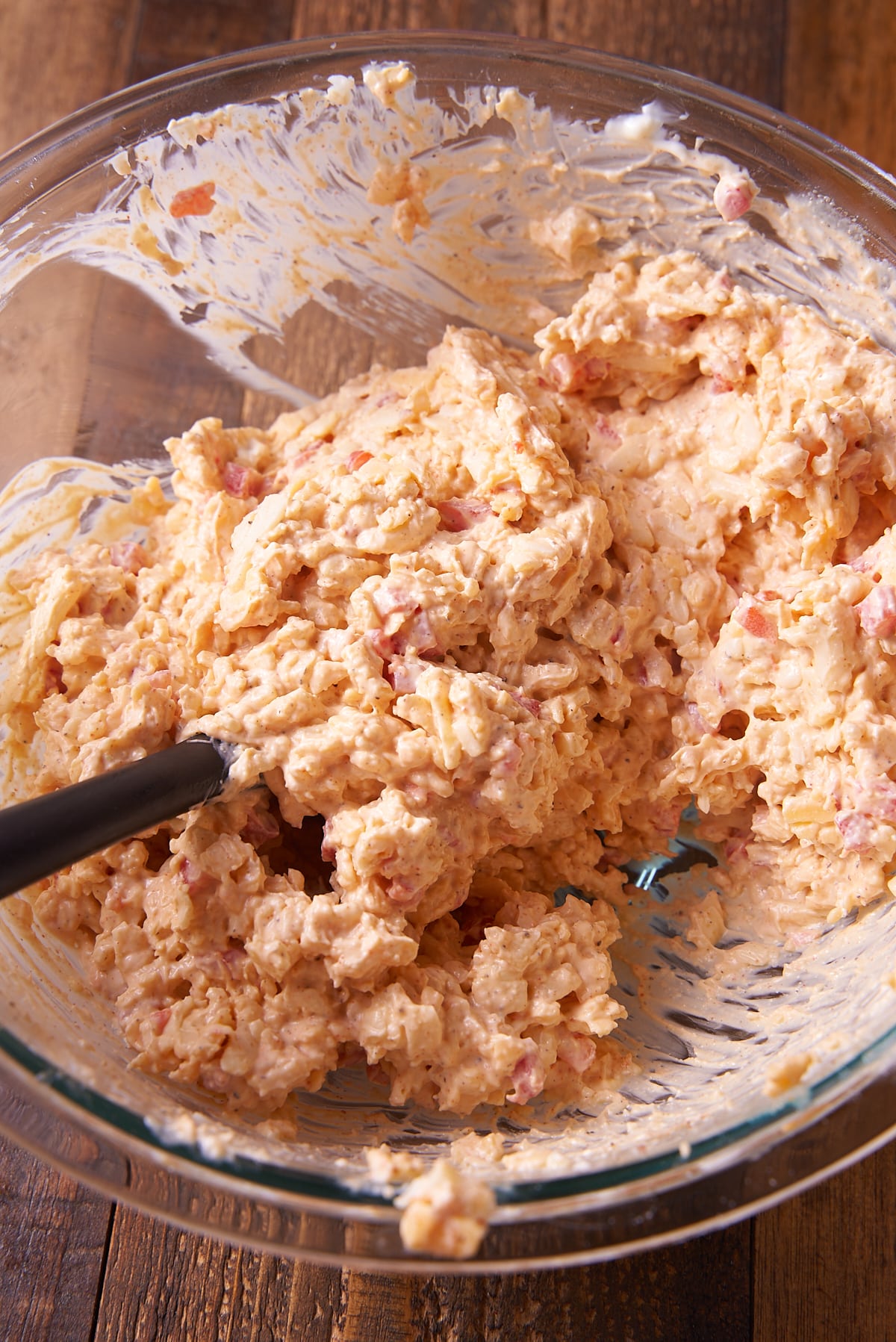 Mixing the pimento cheese in a bowl.