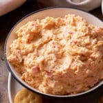 Pimento cheese served in a bowl next to crackers.