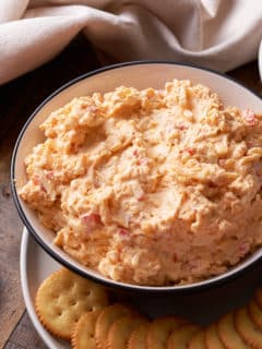 Pimento cheese served in a bowl next to crackers.