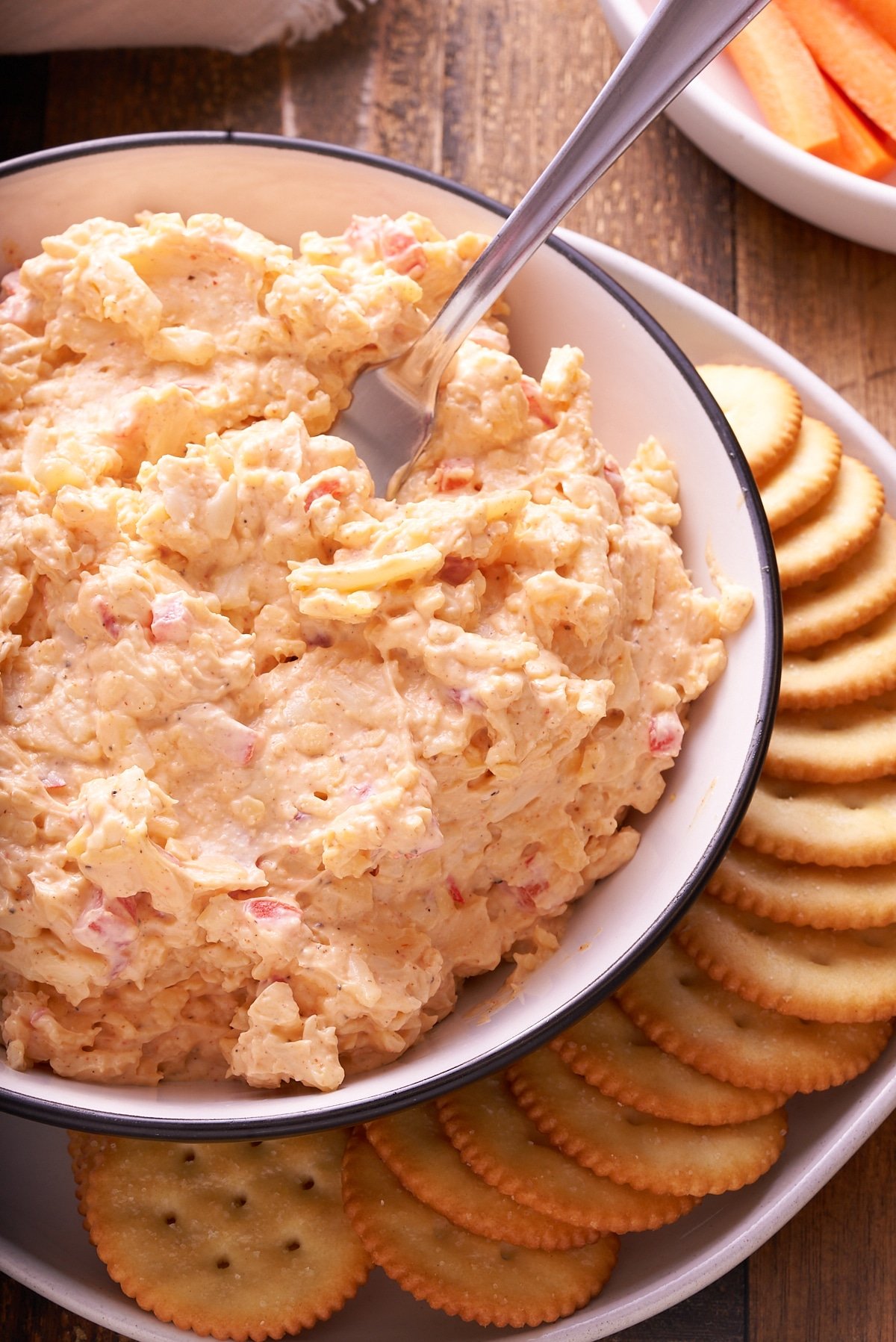 Pimento cheese served in a bowl next to crackers.