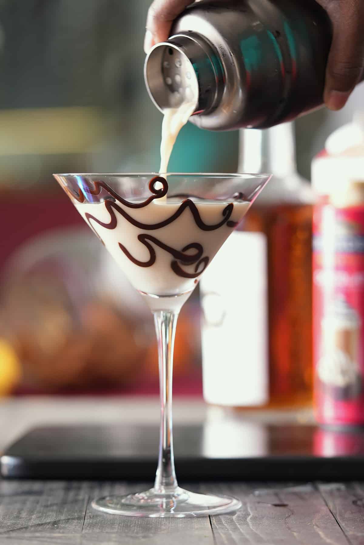 martini being poured into the glass.