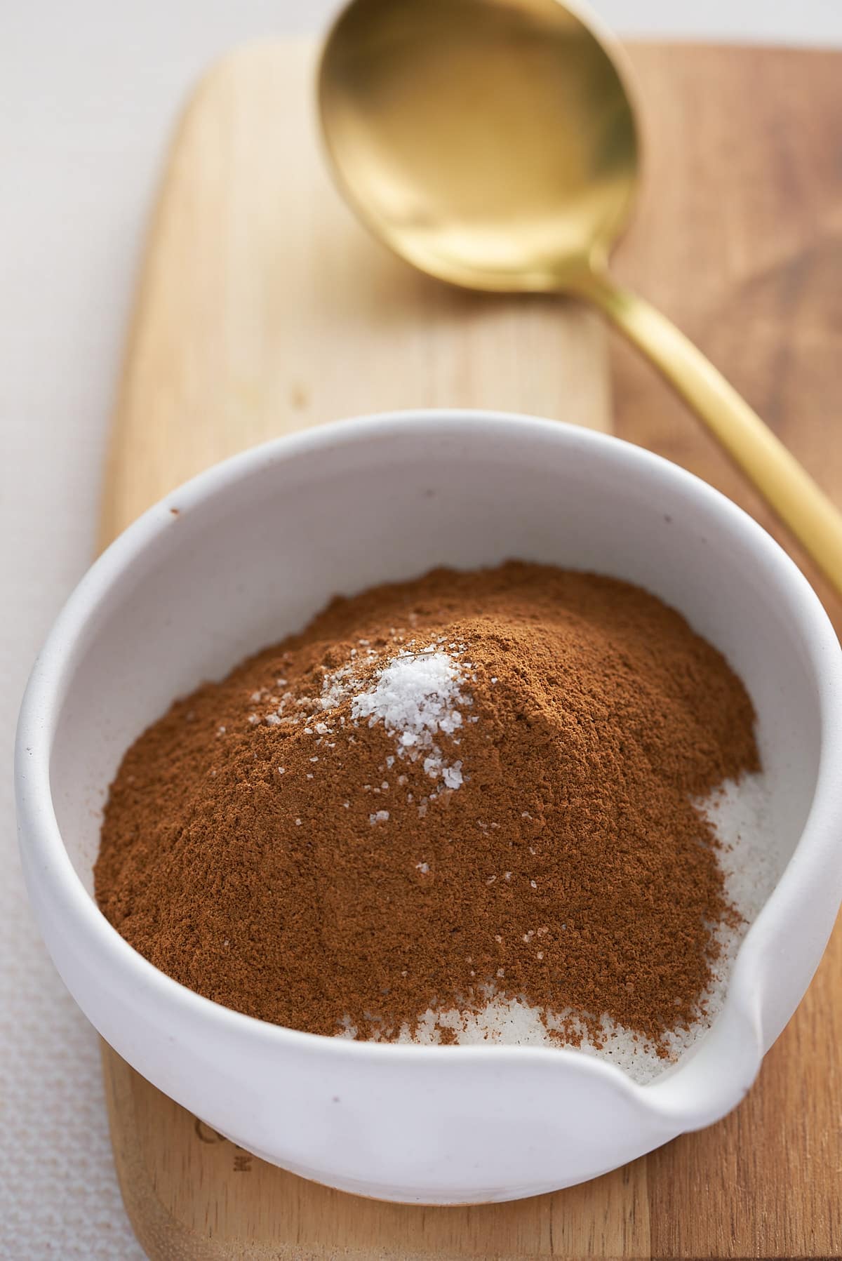 A white bowl filled with cinnamon sugar recipe ingredients.